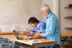 business man working on laptop with Colleges indoor