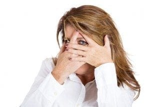 Closeup portrait, mature woman shy and flirting with hands covering entire face except one wide open eye looking at you, camera, isolated white background. Negative human emotion facial expressions