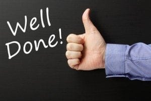 Thumbs Up and a Well Done! on a blackboard